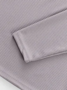 Macro view of purple ribbed knit fabric and sleeve cuff on this men's casual shirt