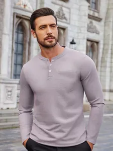 Macro view of men's waffle knit long-sleeve Henley shirt featuring buttoned neckline