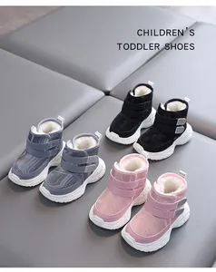 Close-up of colorful winter fleece-lined baby snow boots with velcro straps and soft soles.
