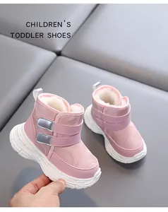 Close-up of pink toddler snow boots with warm white fur lining and textured non-slip sole