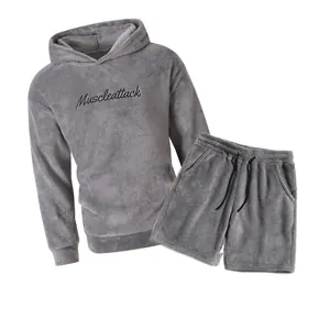 Detail view of grey fleece hoodie and shorts set with Muscleattack embroidery design