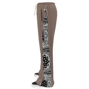 Detail shot of brown wide-leg pants with snap buttons and paisley lining.