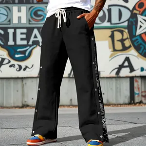 Men's streetwear black snap button sweatpants with paisley print details on the side