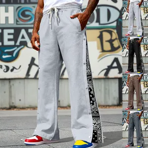 Men's wide-leg sweatpants with snap buttons and paisley side panel detail
