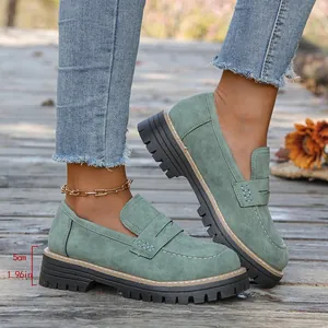 Detailed macro view of sage green platform loafers featuring 5cm thick lug soles and stitching