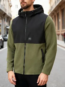 Macro view of olive green and black hooded fleece jacket for men with full-zip closure.