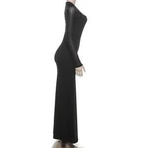 Elegante abito lungo nero aderente visto di lato con maniche lunghe in rete velata.