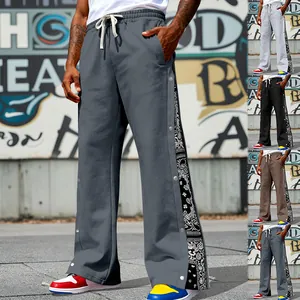 Detail view of men's side snap button sweatpants with trendy paisley pattern side panels