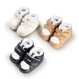 Detailed view of three pairs of warm baby winter boots in cream, tan, and navy colors