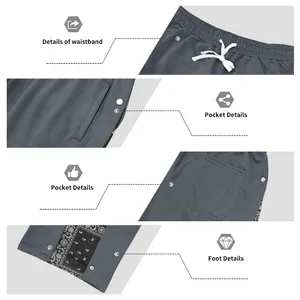 Close-up details of snap-button sports pants with paisley print and elastic waistband.