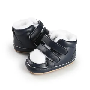 Detail view of baby winter boots with navy blue leather and white faux fur lining
