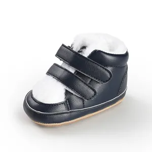 Detailed side view of navy blue warm baby winter boots with thick white faux fur lining
