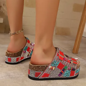 Close-up of bohemian rhinestone platform sandals with colorful beads and cork sole