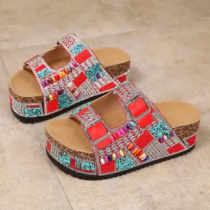 Detailed view of women's platform sandals with vibrant rhinestones and double buckles.