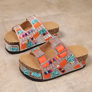 Detailed side view of rhinestone platform sandals with colorful bead decorations