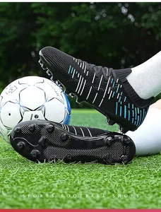 Detail view of professional long-spike football shoes with traction outsole on grass
