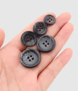 Macro view of high-quality grey marble texture four-hole urea buttons for premium workwear
