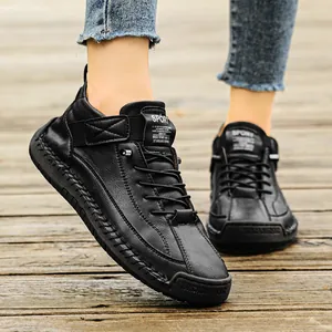 Close-up of black leather mid-top Martin boots with hand-stitched detailing