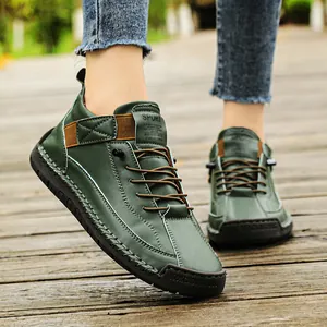 Close-up detail of durable green men's mid-top leisure boots featuring hand-stitched seams