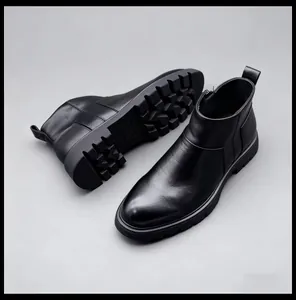 Détail des bottines Chelsea en cuir noir pour hommes avec une semelle épaisse crantée.