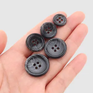 Assorted sizes of marbled dark grey urea buttons for high-end garments and workwear