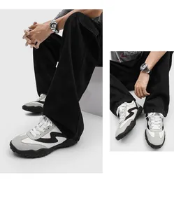 Close-up detail showing side and top-down views of men's grey and white German trainers