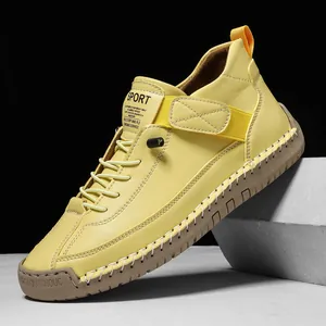 Yellow mid-top men's Martin boots featuring hand-stitched details and durable rubber sole