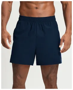 Close-up detail of men's navy blue quick-dry breathable athletic shorts on a fitness model