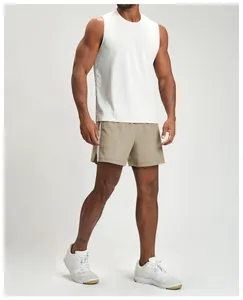 Side view of a model wearing khaki quick-dry athletic shorts with white side stripes