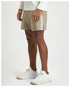 Side view of men's khaki quick-dry athletic shorts featuring a white contrast stripe detail