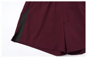 Close-up detail of men's quick-dry sports shorts showing grey color blocking and stitching