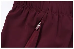 Close-up detail of zippered side pocket on maroon quick-dry men's athletic shorts.