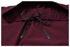 Close-up detail of maroon sports shorts waistband featuring a black adjustable drawstring
