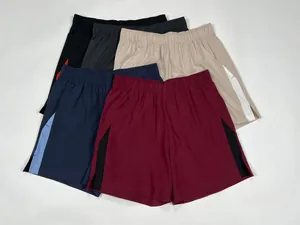 Detailed view of men's color-block quick-dry sports shorts in various colors