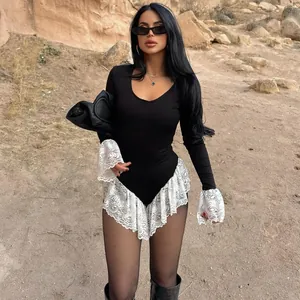 Chic black long sleeve slim fit bodysuit featuring white lace trim detail on a model outdoors