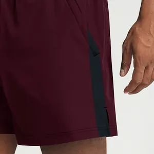 Men's quick-dry burgundy sports shorts with black side stripe for fitness and soccer