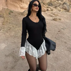 Detail view of a slim black bodysuit featuring elegant white lace ruffles at the cuffs.