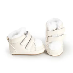 Detailed view of cream baby walking shoes with white faux fur lining and velcro straps