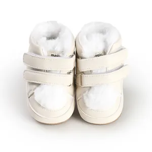 Detailed close-up of cream baby winter boots with soft white fur lining and dual straps