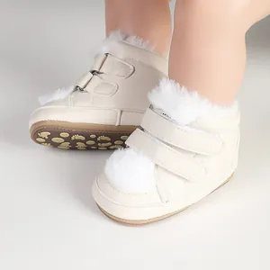 Detail of beige baby walking shoes with soft fur trim and anti-slip patterned sole