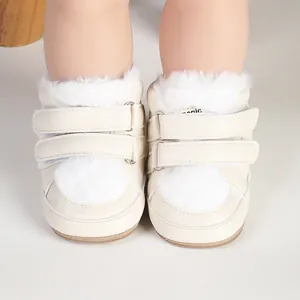 Close-up of cream baby walking shoes featuring soft white fur trim and double hook-and-loop straps.
