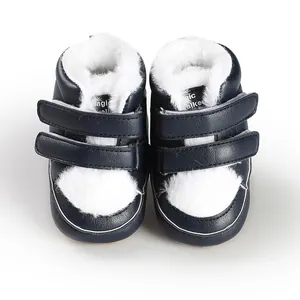 Close-up of navy baby walking shoes with warm white faux fur lining and straps