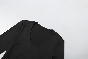 Detail view showing the deep round neckline of a slim fit black long sleeve bodysuit.