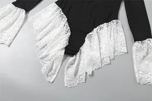 Detail of white lace ruffles on a slim-fit long sleeve bodysuit with color block design.