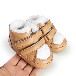 Detailed view of tan baby first walker shoes featuring white faux fur lining and velcro straps