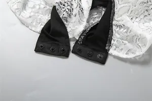 Detailed macro view showing the snap button closures and delicate lace fabric of the bodysuit