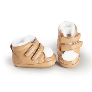 Detailed close-up of tan faux leather baby walking shoes featuring soft white fur lining
