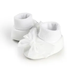 Detail view of white infant walking socks featuring a large elegant satin bow decoration.