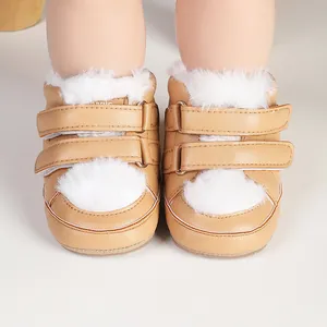 Detail view of brown baby walking shoes with white faux fur trim and Velcro straps.