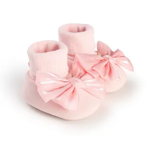 Soft pink baby floor socks featuring a large elegant satin bow for infants and toddlers